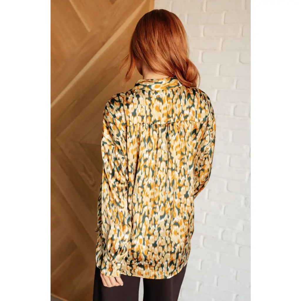 Satin button up blouse with amber and olive abstract print. Lightweight flowy fit that’s plus size office friendly.