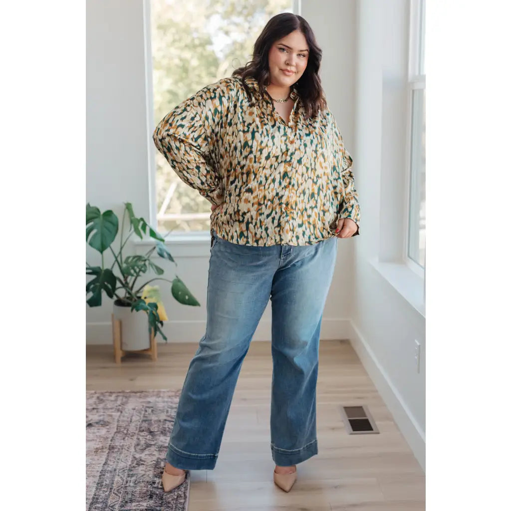 Satin button up blouse with amber and olive abstract print. Lightweight flowy fit that’s plus size office friendly.