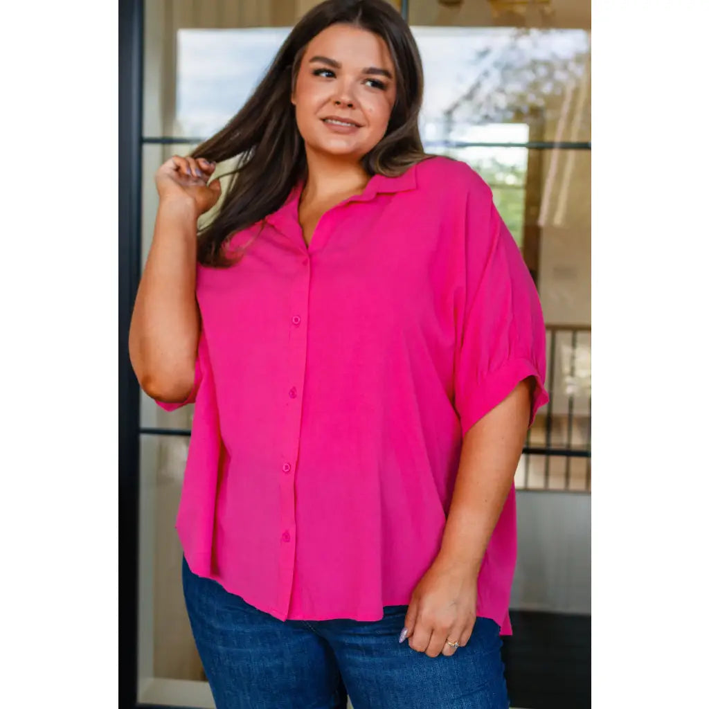 A bold flowy pink blouse with chic dolman sleeves and an oversized fit — plus it’s designed to flatter all sizes