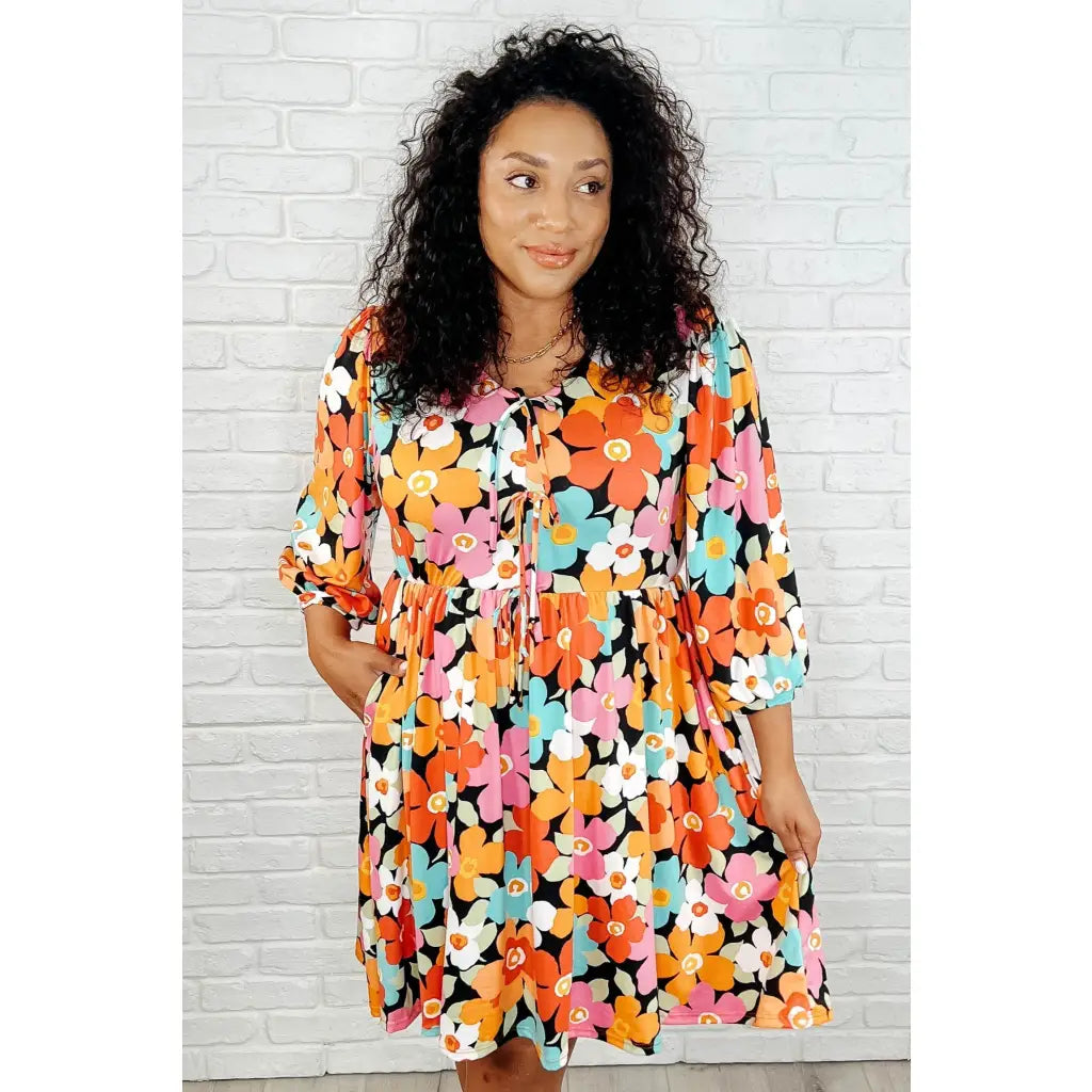 Make a statement in the Bow-dly Go V-Neck Floral Mini Dress. A bold playful vibrant boutique dress buttery soft fabric