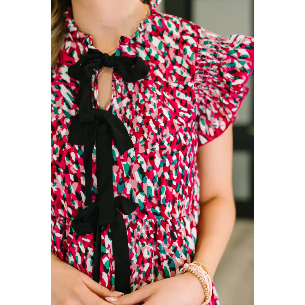 Fuchsia and black mini dress with bow detail flutter sleeves. A-line fit pockets plus sizes available. SM-3XL.