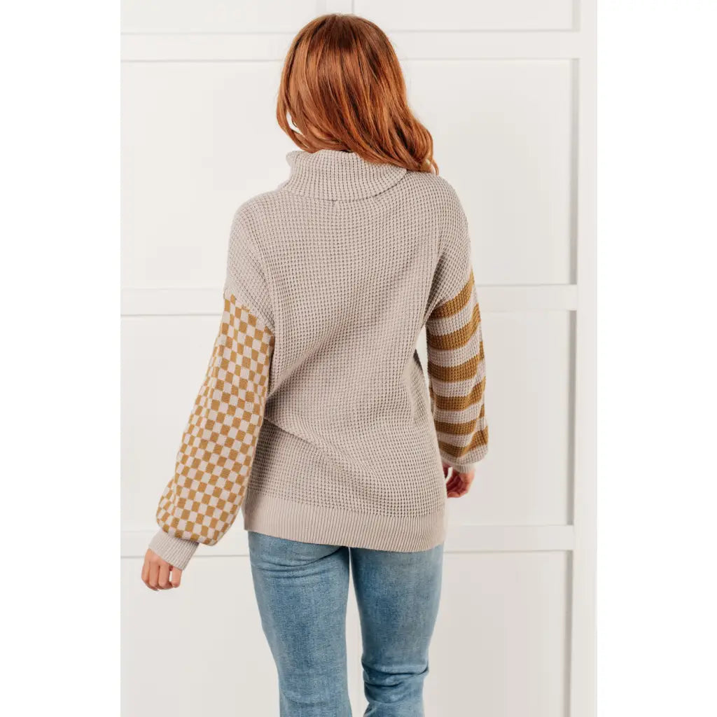 Stay warm in style with this Beige Turtleneck Sweater! Featuring a soft waffle knit and unique design caramel-hued