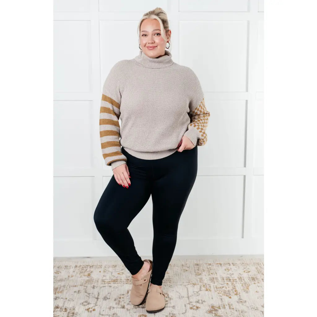Stay warm in style with this Beige Turtleneck Sweater! Featuring a soft waffle knit and unique design caramel-hued