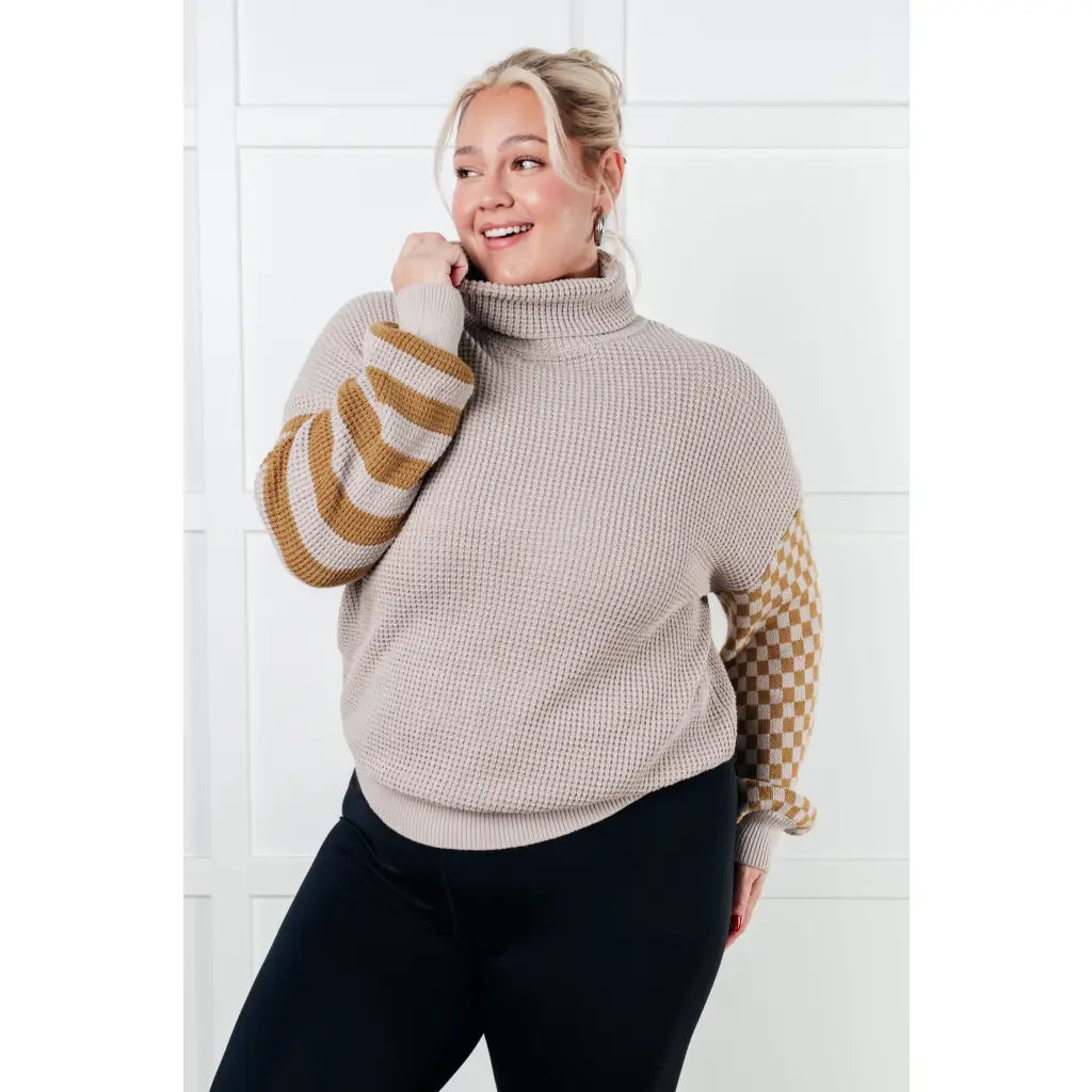 Stay warm in style with this Beige Turtleneck Sweater! Featuring a soft waffle knit and unique design caramel-hued