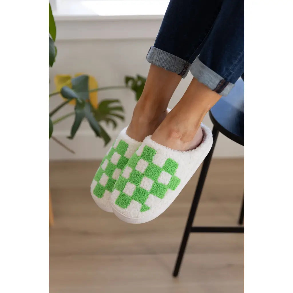Step your way into comfort with these Checked Out Slippers in green and white. Crafted from a warm fuzzy looped French