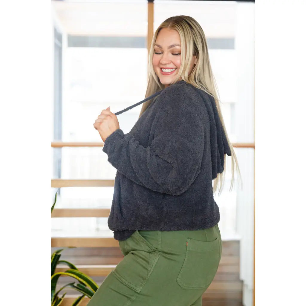 Our Cozy Does It Hoodie In Charcoal is so comfy! The coziness starts with a fuzzy medium weight knit that shapes slight