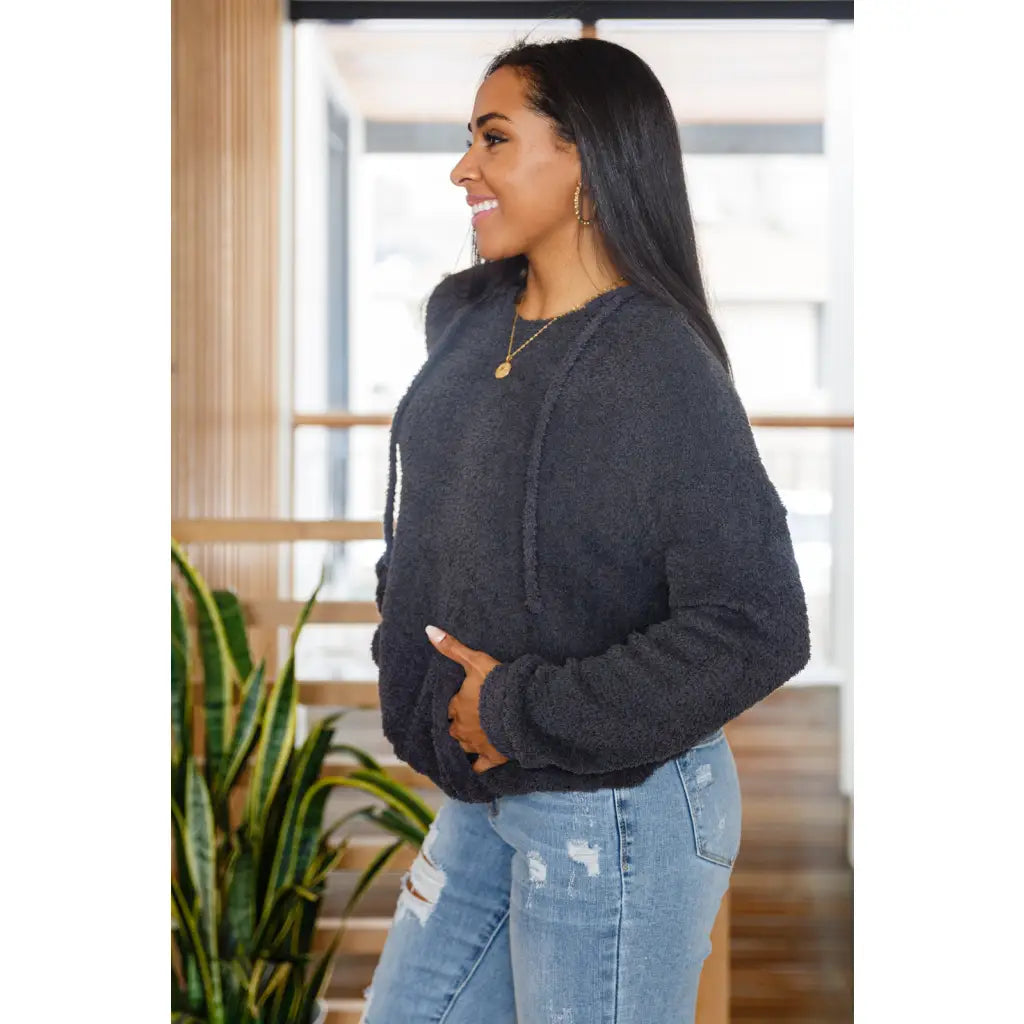 Our Cozy Does It Hoodie In Charcoal is so comfy! The coziness starts with a fuzzy medium weight knit that shapes slight