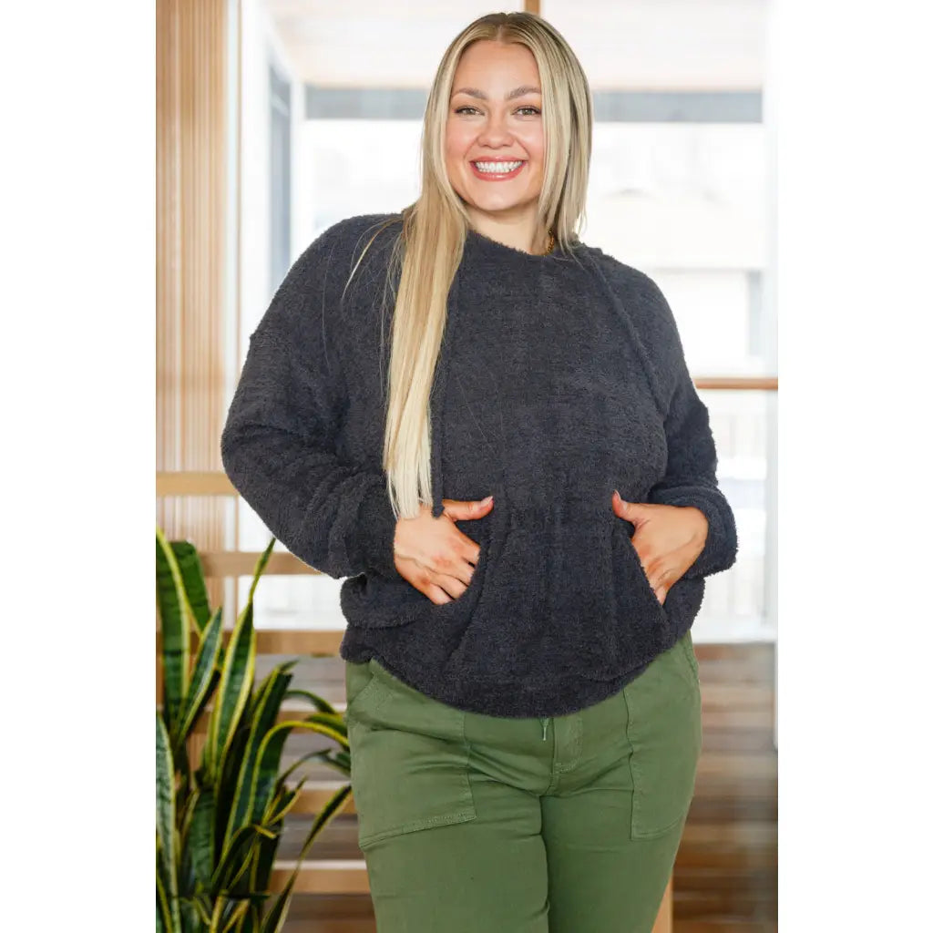 Our Cozy Does It Hoodie In Charcoal is so comfy! The coziness starts with a fuzzy medium weight knit that shapes slight