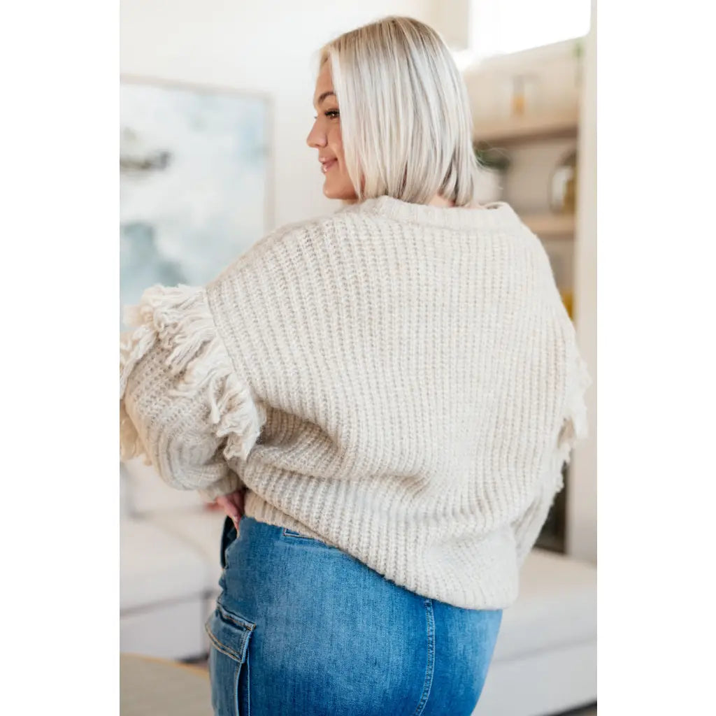 Fringe knit cardigan with button front and V-neckline. Plus sizes available. Cozy boutique layering piece playful