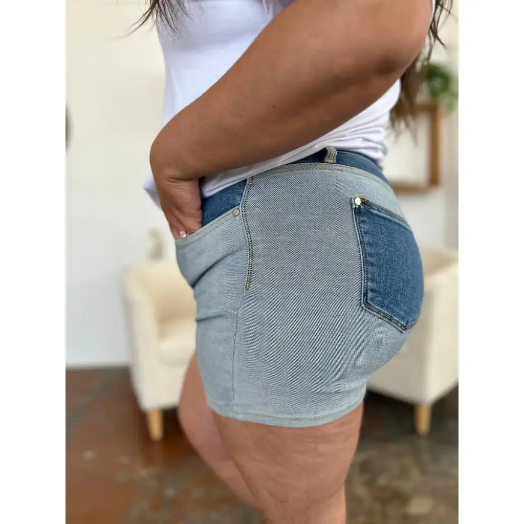 Two-tone Judy Blue denim shorts with color block detail and curve-hugging stretch. Plus size friendly perfect for bold