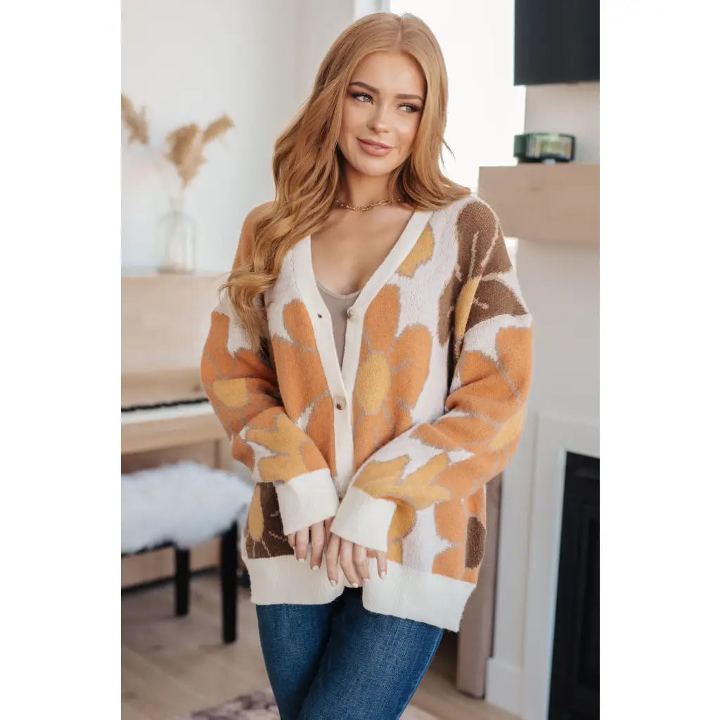 Our Exquisitely Fall Floral Cardigan is a retro mod floral oversized grandpa cardigan featuring an eye-catching large