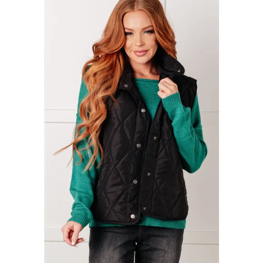 Our Layering Queen Puffer Vest is made from a black quilted windbreaker material. This vest will keep you warm