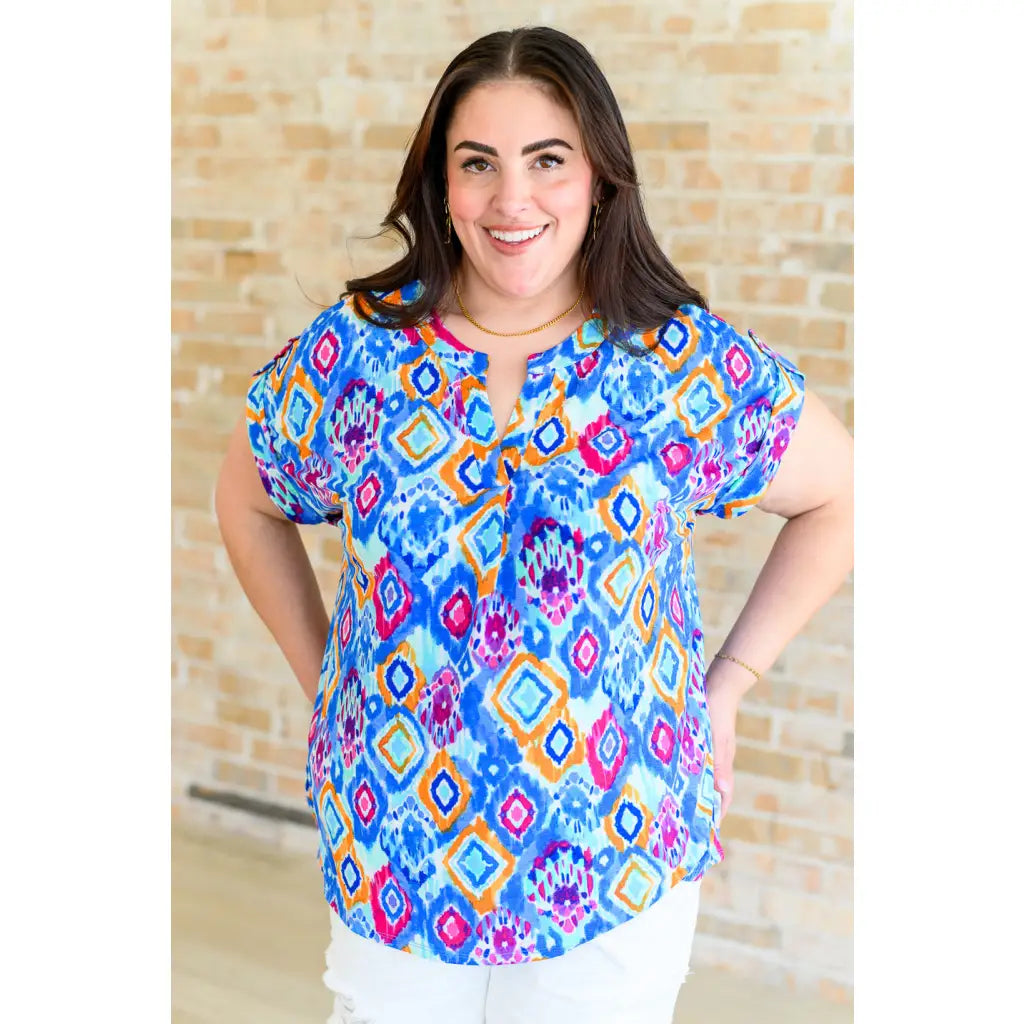 Our Lizzy Cap Sleeve Top in Blue and Magenta Ikat is crafted from light-weight cooling stretchy wrinkle-resistant