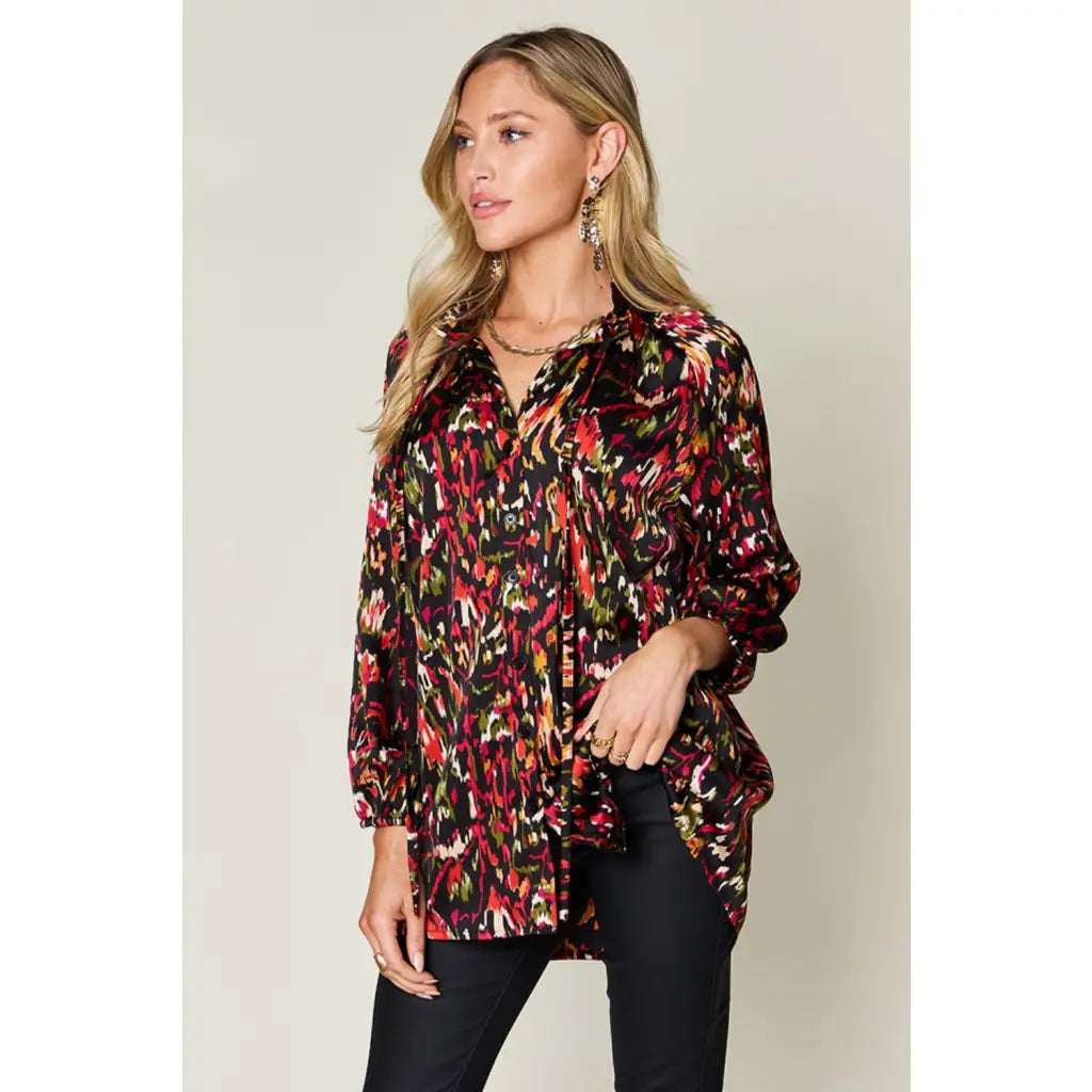 Chic abstract print tunic blouse with flowy fit and ruffled neckline. Sizes SM–3XL. Perfect plus size office top