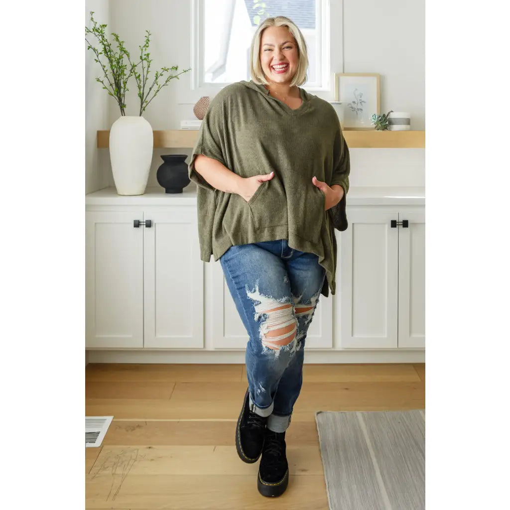 Our Perfectly Poised Hooded Poncho is crafted from a soft olive lightweight and stretchy. ribbed jersey knit.