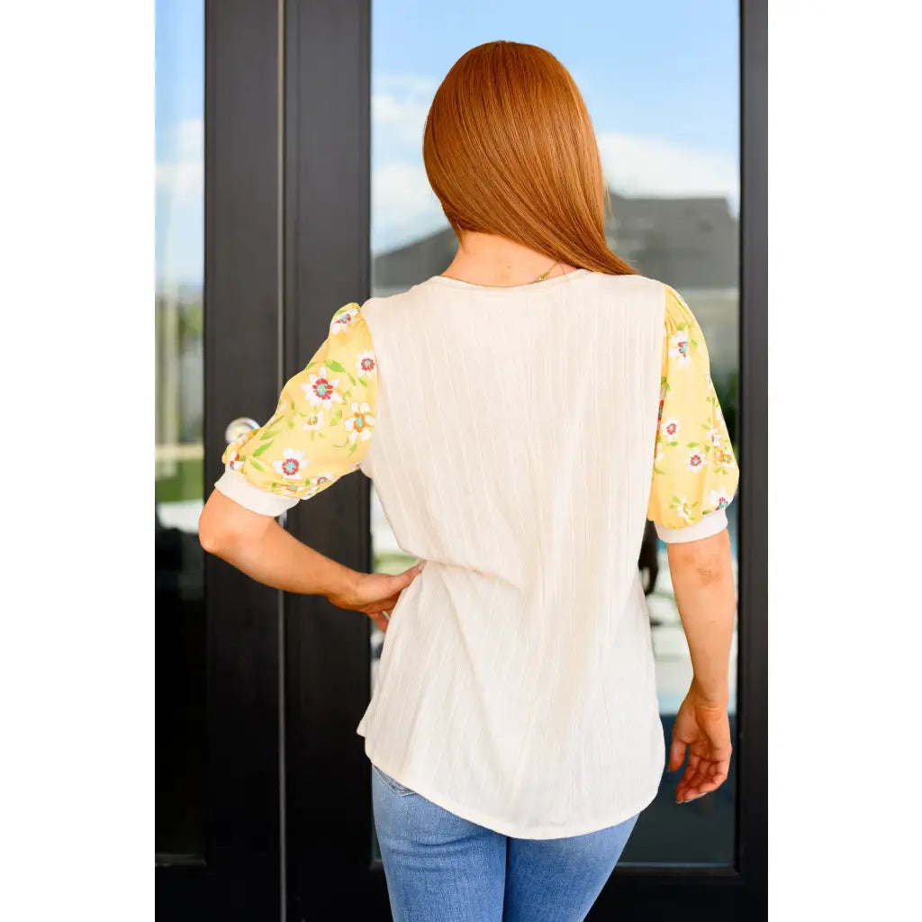 The Primrose Puff Sleeves Top blends soft ribbed knit with elegant floral puff sleeves. A chic and cute spring