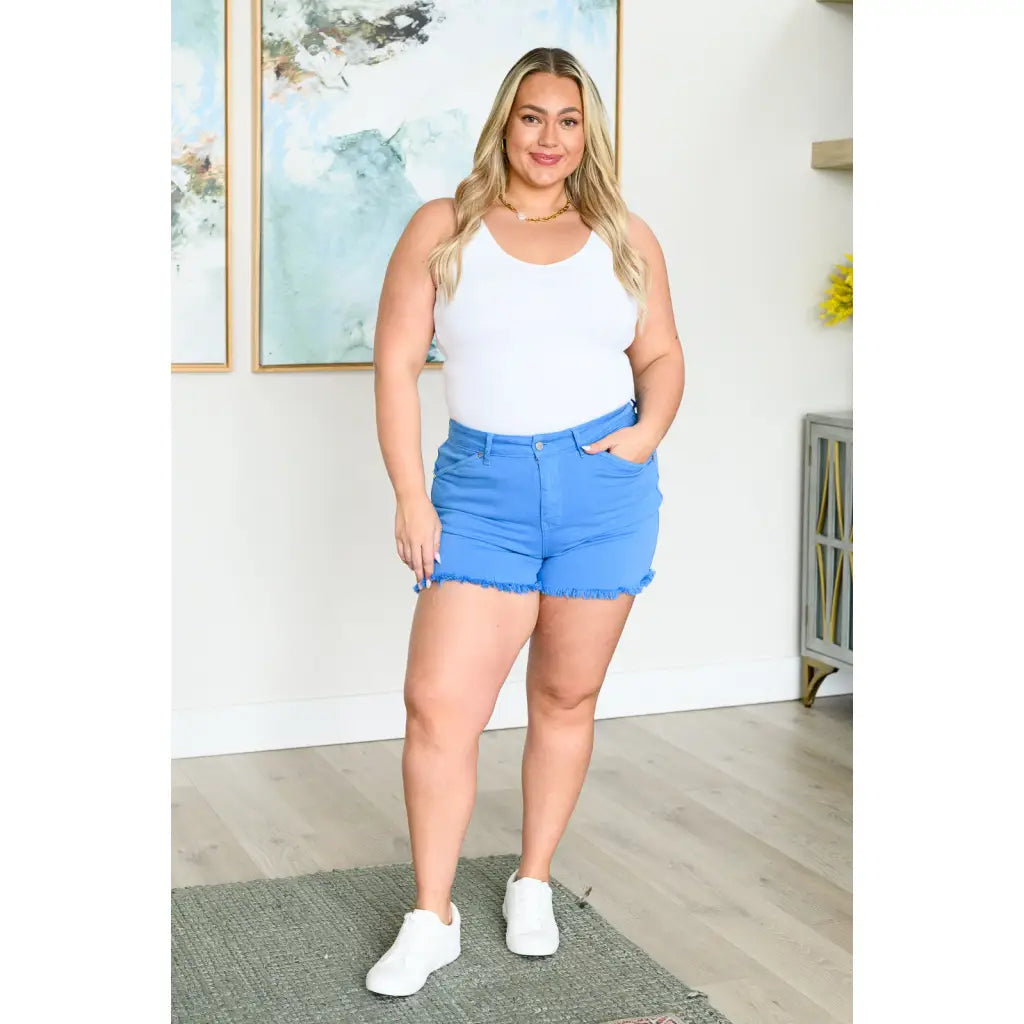 Mid rise Judy Blue shorts with raw hem and stretch. Flattering fit for standard curvy plus sizes. Spring summer denim