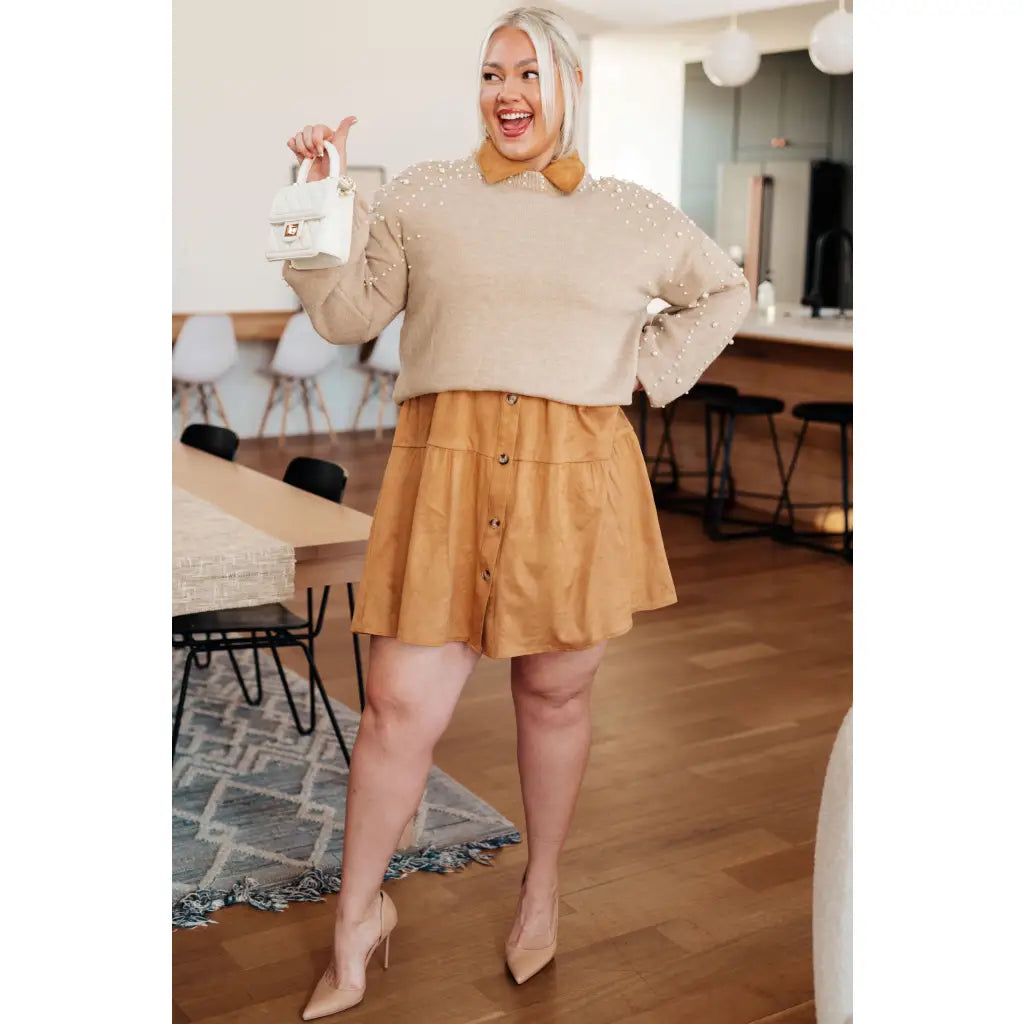 Stay stylish and cozy with our String Me Along Pearl Accent Beige Sweater. Made from lightweight knit this sweater