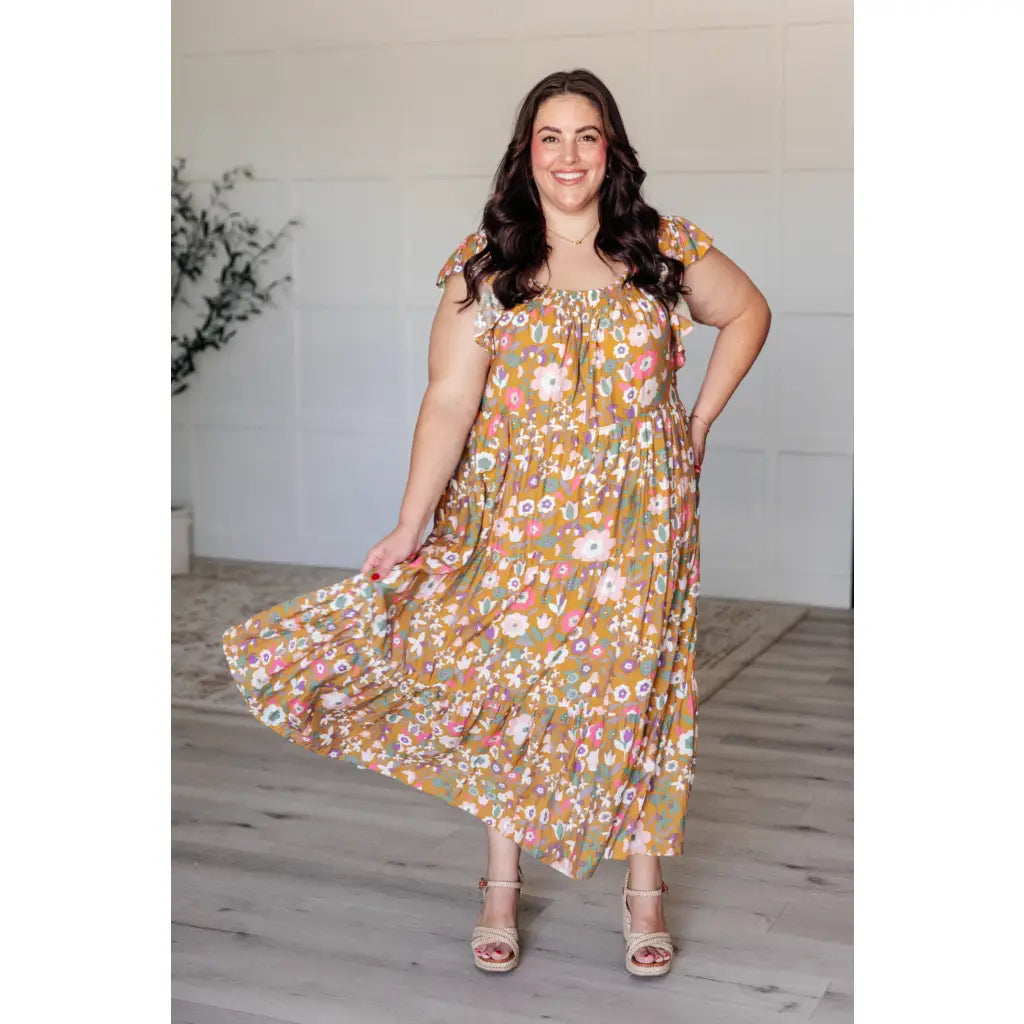 Flowy floral boho midi dress with smocked neckline flutter sleeves and tiered design. Size inclusive from Small to 3XL