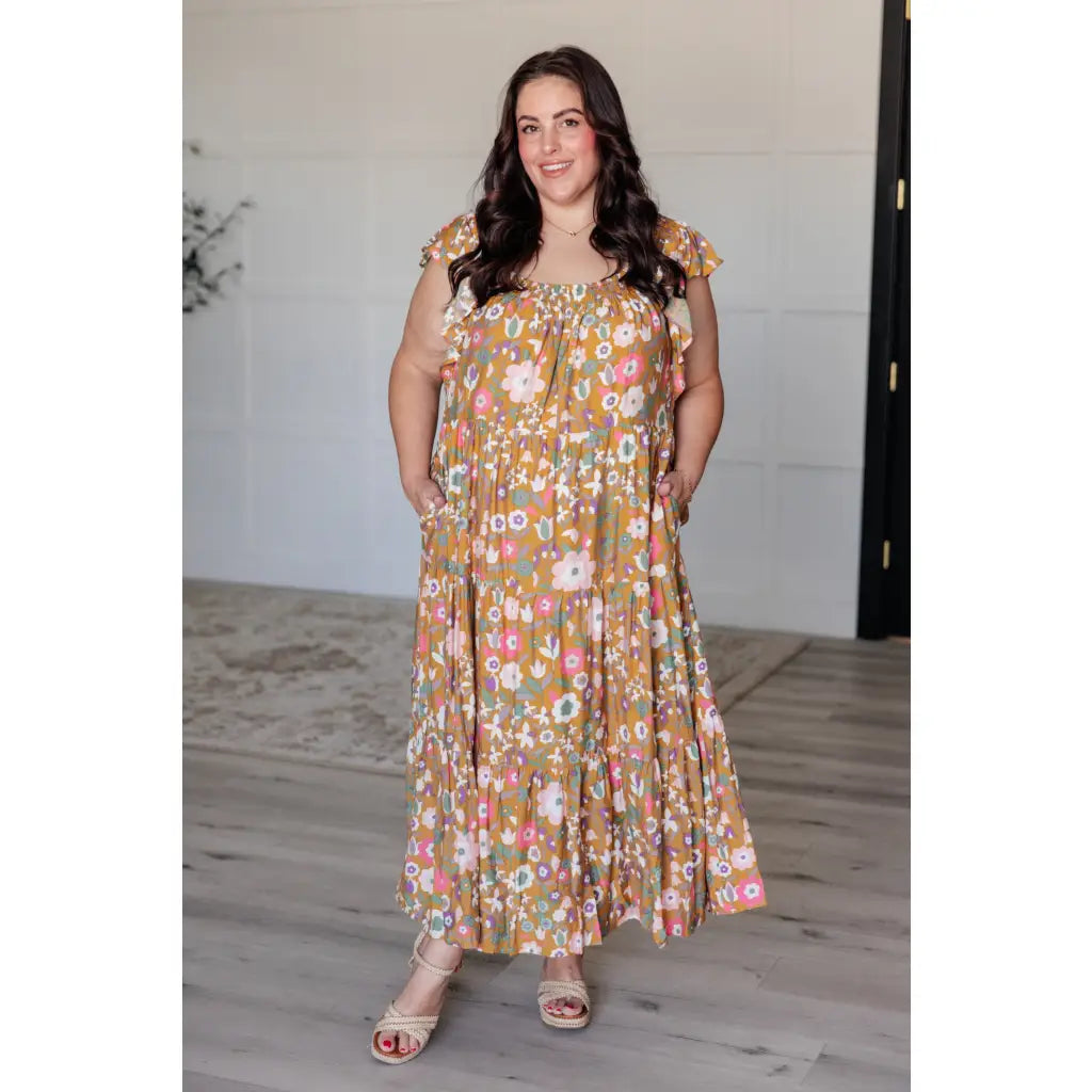 Flowy floral boho midi dress with smocked neckline flutter sleeves and tiered design. Size inclusive from Small to 3XL