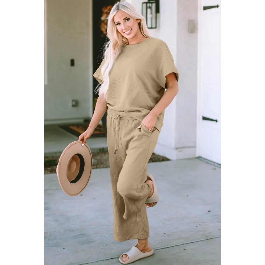 Our Textured Bae Short Sleeve Top and Pants Set is anything but basic. Featuring a drawstring wide leg cropped pant