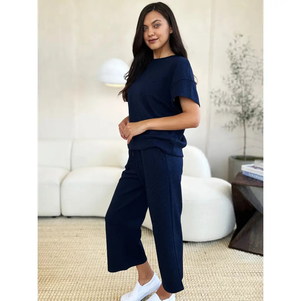 Our Textured Bae Short Sleeve Top and Pants Set is anything but basic. Featuring a drawstring wide leg cropped pant