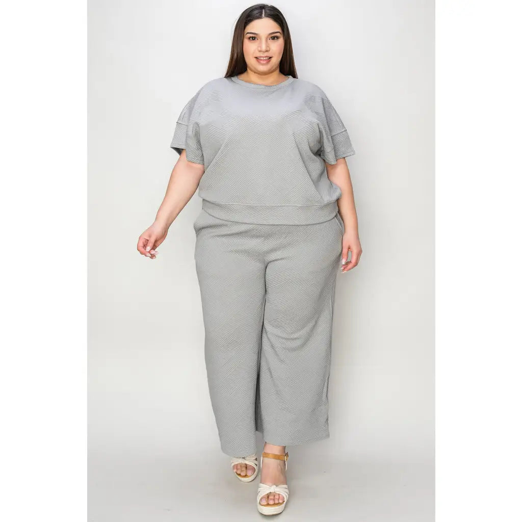 Our Textured Bae Short Sleeve Top and Pants Set is anything but basic. Featuring a drawstring wide leg cropped pant