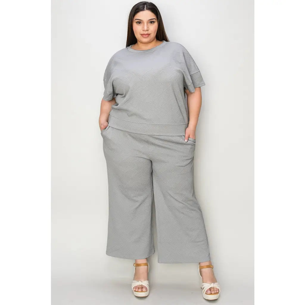 Our Textured Bae Short Sleeve Top and Pants Set is anything but basic. Featuring a drawstring wide leg cropped pant