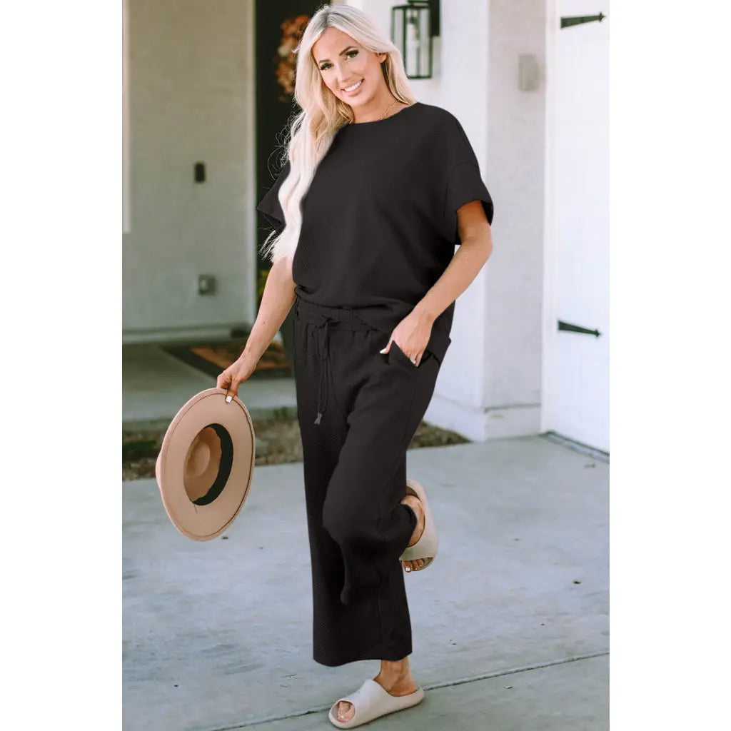 Our Textured Bae Short Sleeve Top and Pants Set is anything but basic. Featuring a drawstring wide leg cropped pant