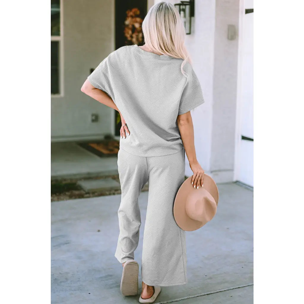 Our Textured Bae Short Sleeve Top and Pants Set is anything but basic. Featuring a drawstring wide leg cropped pant