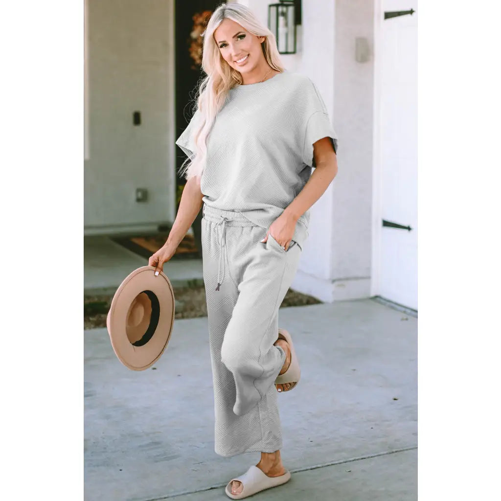 Our Textured Bae Short Sleeve Top and Pants Set is anything but basic. Featuring a drawstring wide leg cropped pant