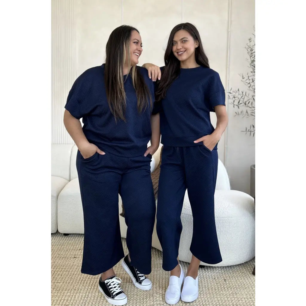 Our Textured Bae Short Sleeve Top and Pants Set is anything but basic. Featuring a drawstring wide leg cropped pant