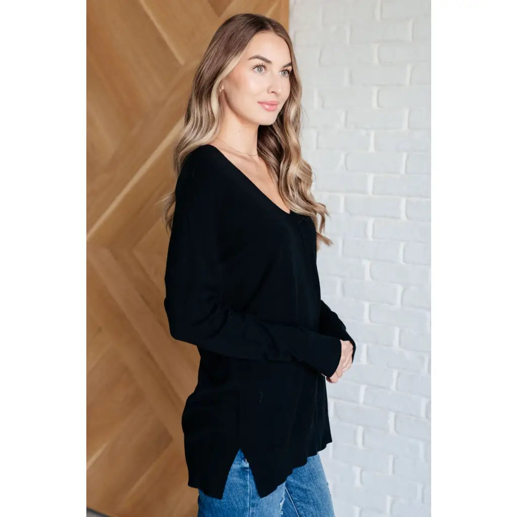 Our V-Neck Front Seam Sweater in black add a stylish touch to your closet! The dropped shoulder and relaxed fit