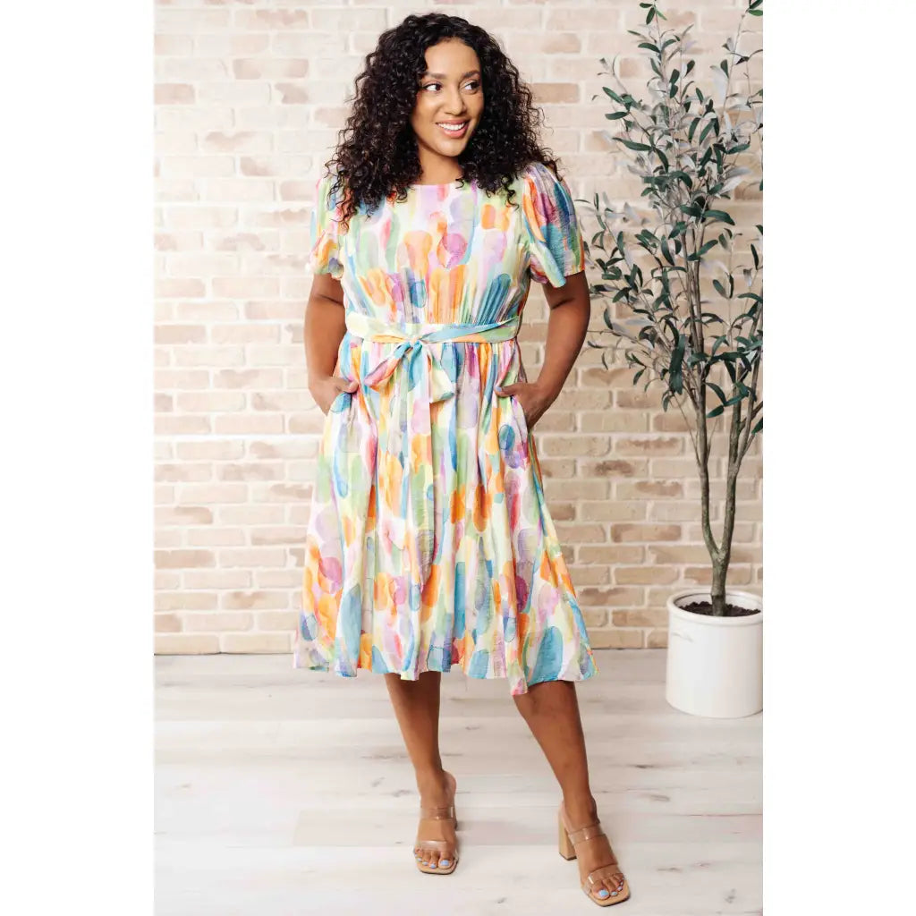 Midi dress with abstract watercolor print sleeves and flattering fit. Available in standard plus size. Spring ready