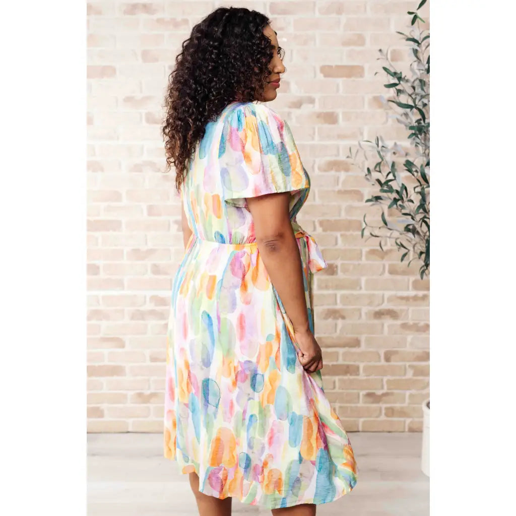 Midi dress with abstract watercolor print sleeves and flattering fit. Available in standard plus size. Spring ready