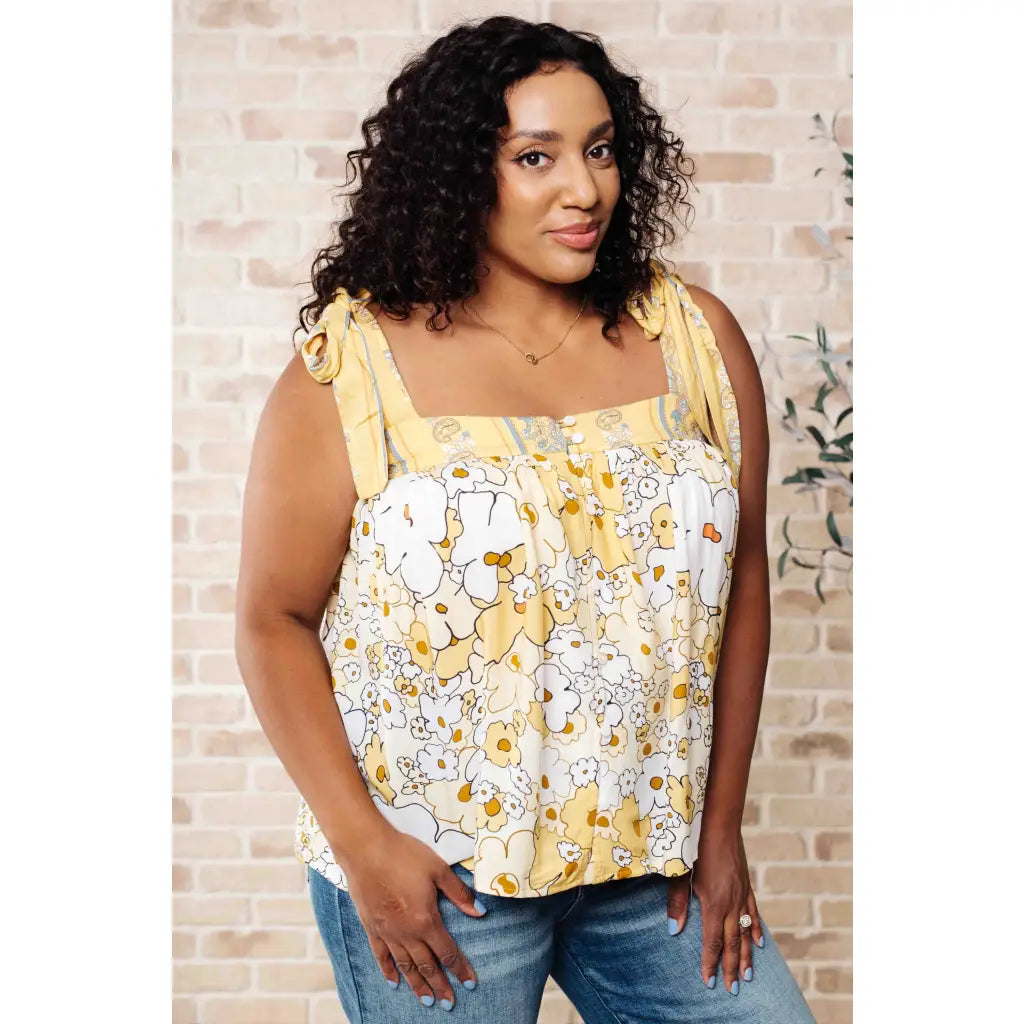 Our What’s Happening Here Yellow Floral Tank is playful and feminine! It features a woven fabric functional shoulder