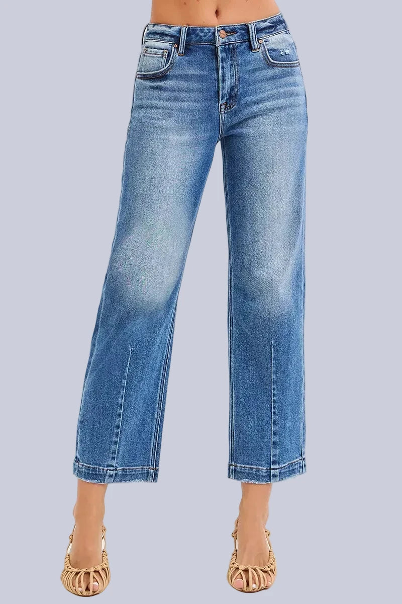 Model wearing Café Chic High Rise Cropped Boyfriend RISEN Jeans in a medium wash with a relaxed cropped boyfriend fit.