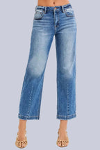 Model wearing Café Chic High Rise Cropped Boyfriend RISEN Jeans in a medium wash with a relaxed cropped boyfriend fit.