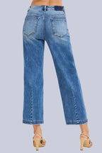 Model wearing Café Chic High Rise Cropped Boyfriend RISEN Jeans in a medium wash with a relaxed cropped boyfriend fit.