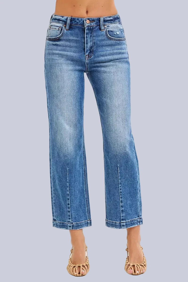 Model wearing Café Chic High Rise Cropped Boyfriend RISEN Jeans in a medium wash with a relaxed cropped boyfriend fit.