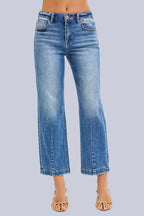Model wearing Café Chic High Rise Cropped Boyfriend RISEN Jeans in a medium wash with a relaxed cropped boyfriend fit.