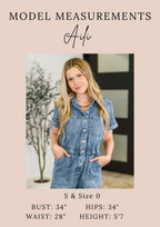 Woman wearing a denim jumpsuit with model measurements displayed.