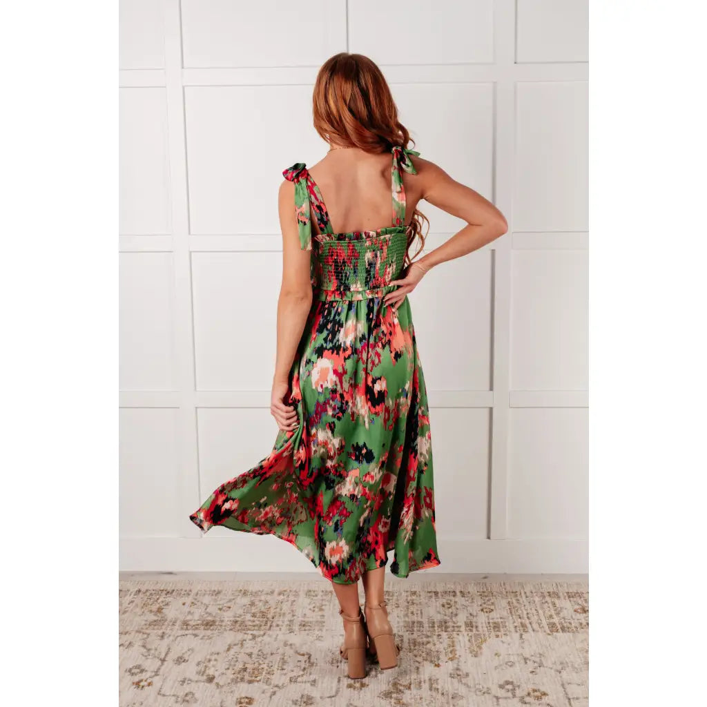 Romantic lush green floral midi dress with a smocked bodice and self-tie straps perfect for spring or summer. Available