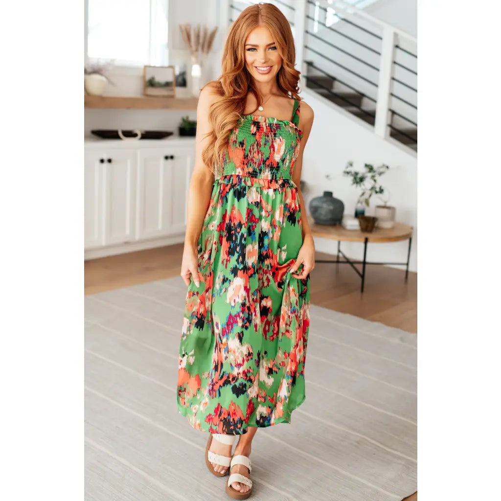 Romantic lush green floral midi dress with a smocked bodice and self-tie straps perfect for spring or summer. Available