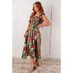 Romantic lush green floral midi dress with a smocked bodice and self-tie straps perfect for spring or summer. Available