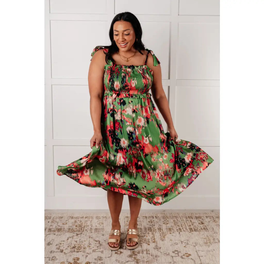 Romantic lush green floral midi dress with a smocked bodice and self-tie straps perfect for spring or summer. Available