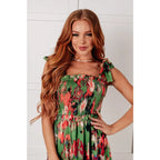 Romantic lush green floral midi dress with a smocked bodice and self-tie straps perfect for spring or summer. Available