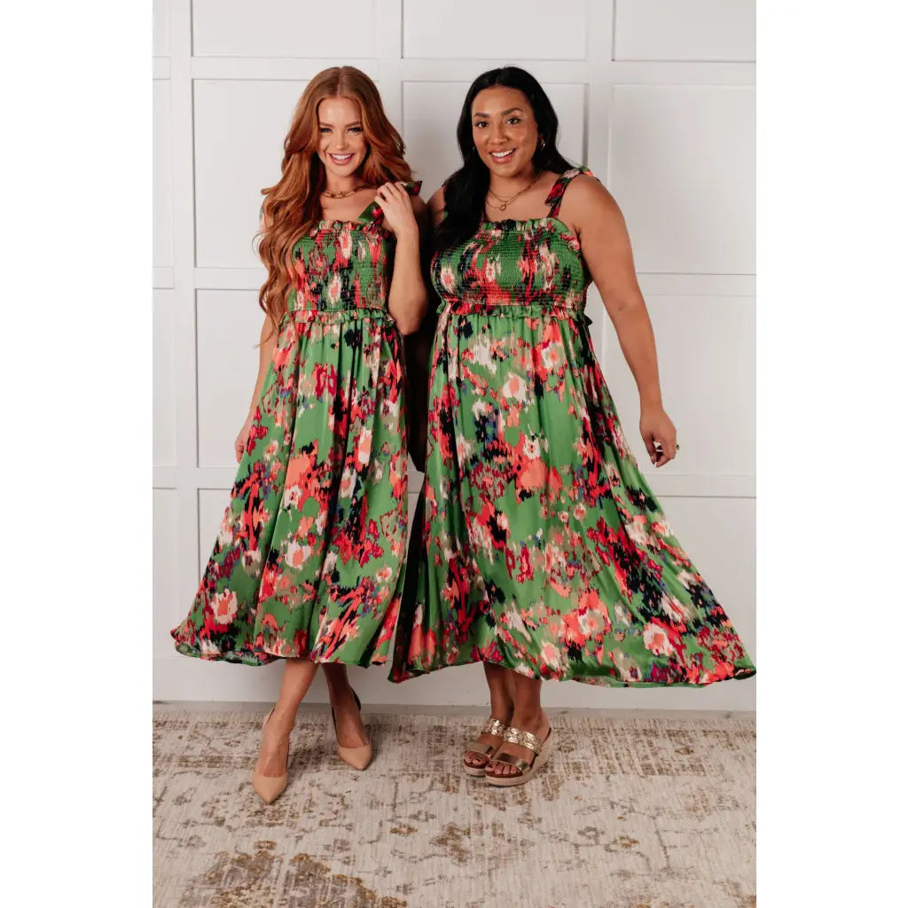 Romantic lush green floral midi dress with a smocked bodice and self-tie straps perfect for spring or summer. Available