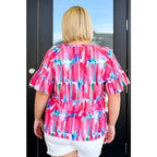 Show your bold side in the Abstract Art V-Neck Blouse plus. Hot pink magenta teal and white make it a standout.