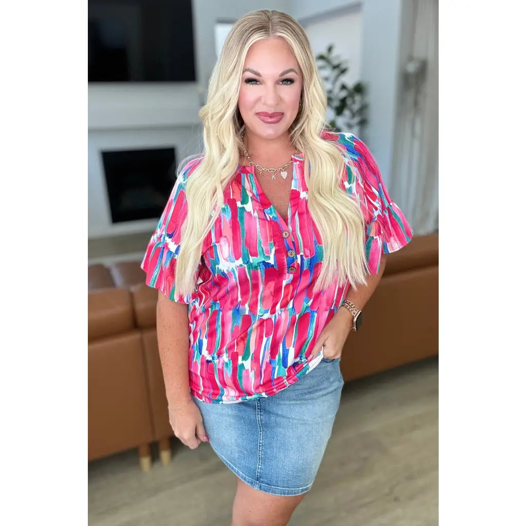 Show your bold side in the Abstract Art V-Neck Blouse plus. Hot pink magenta teal and white make it a standout.